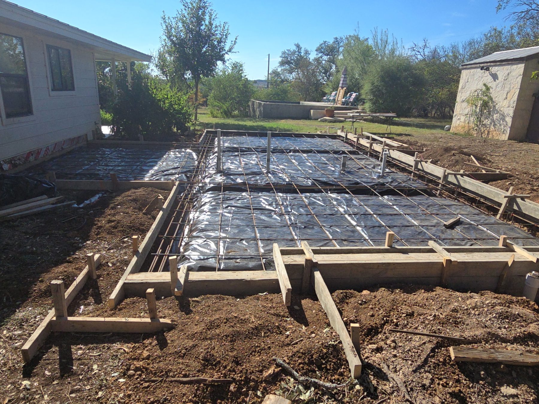 Footing forms and rebar beside a house