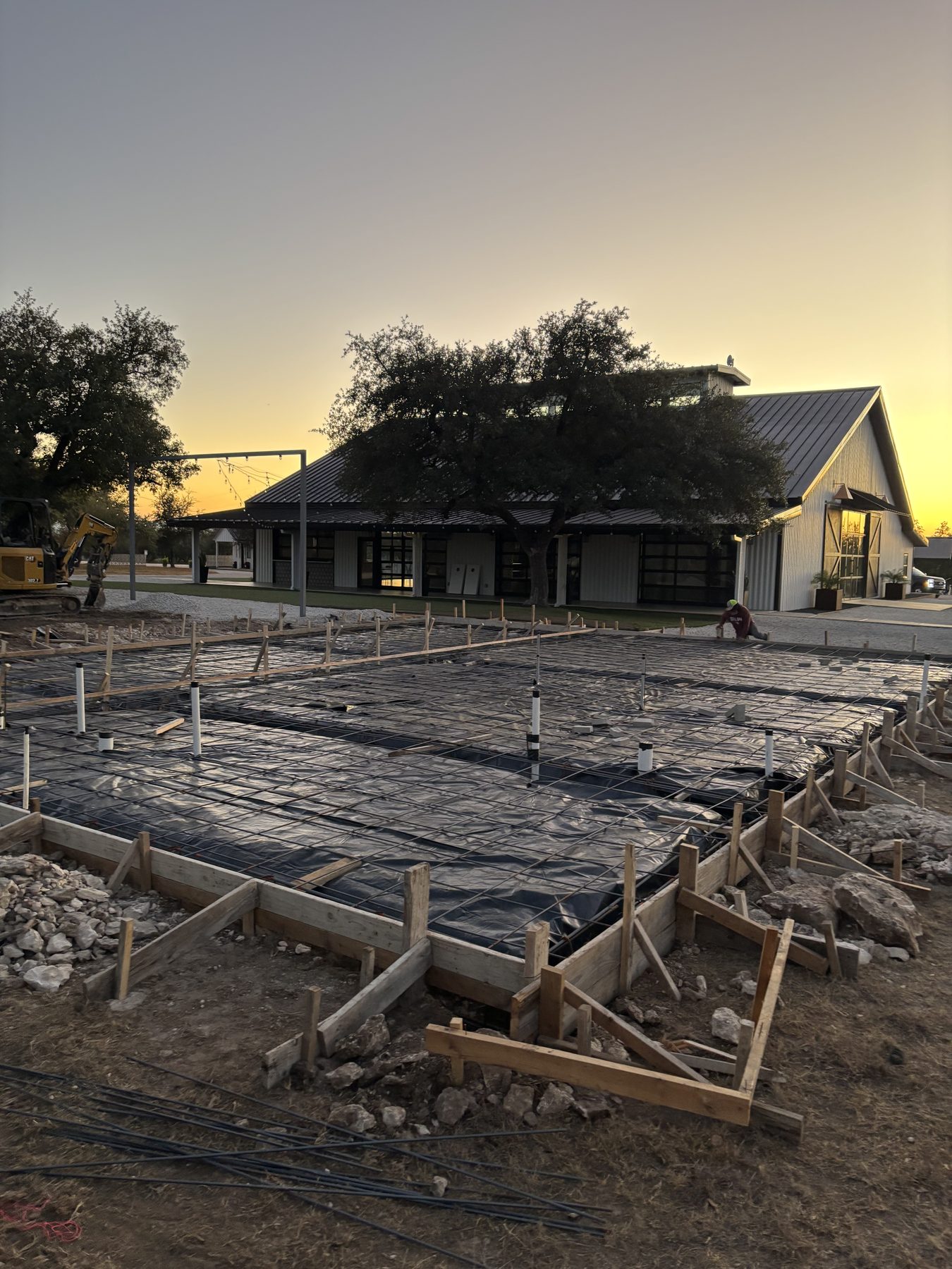 Foundation forms in front of the house at sunset